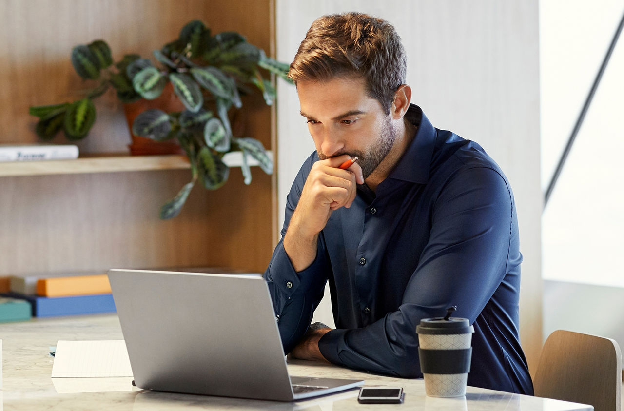 Person sitting with laptop at table