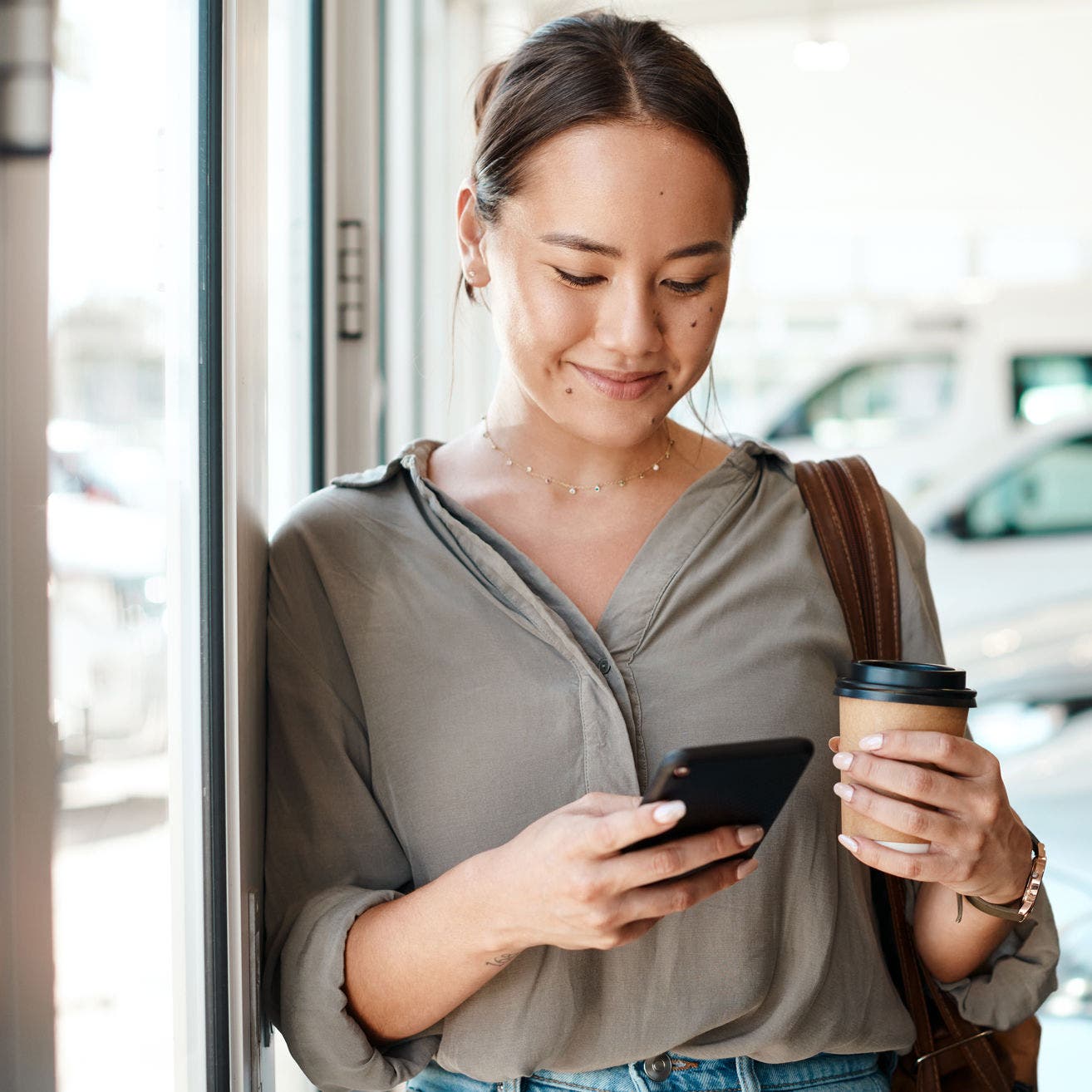 woman using smartphone in coffee shop