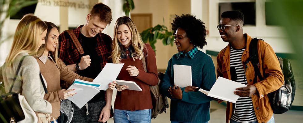 Diverse group of students looking at and holding notes