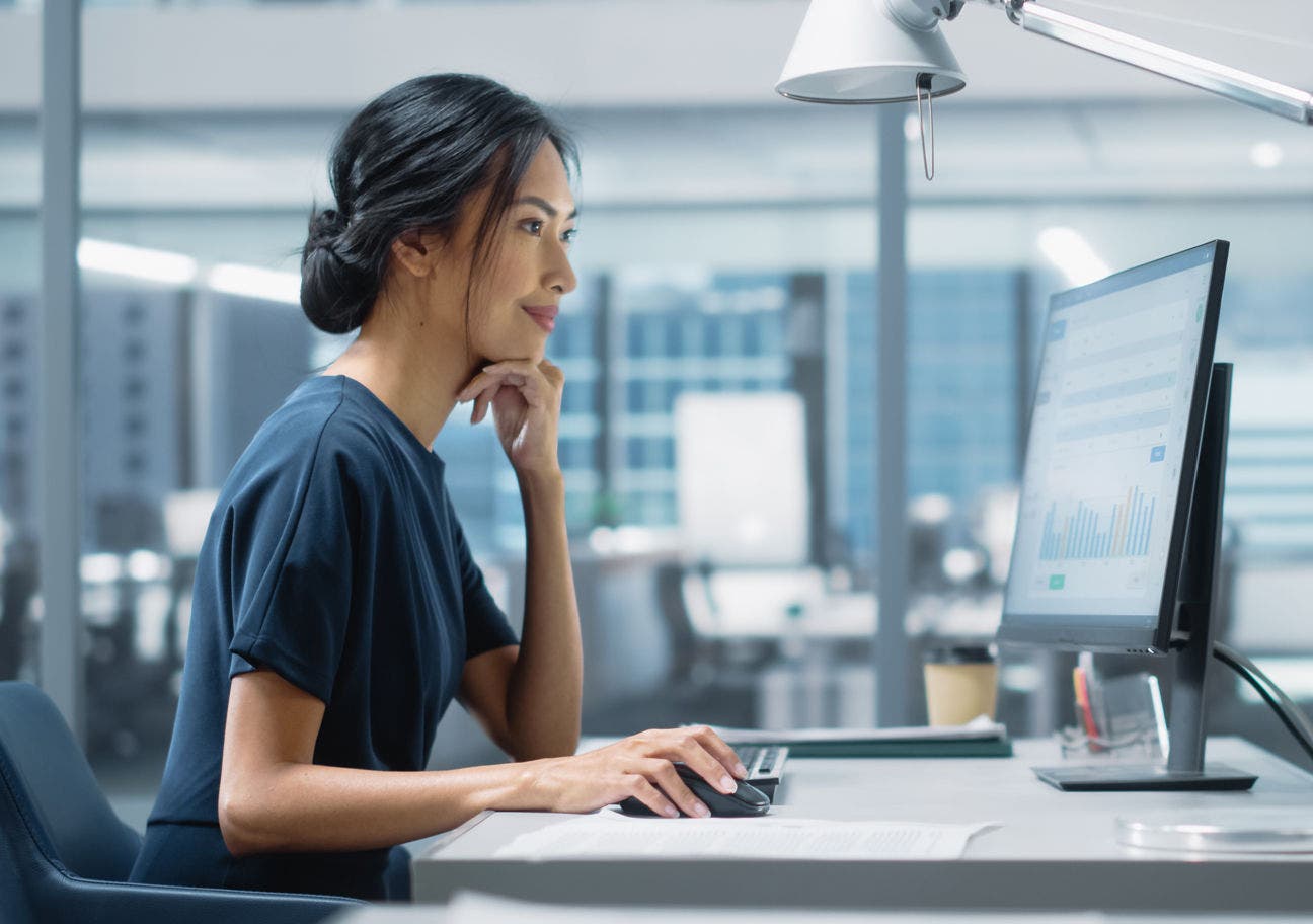 woman in a high-tech office using a desktop computer