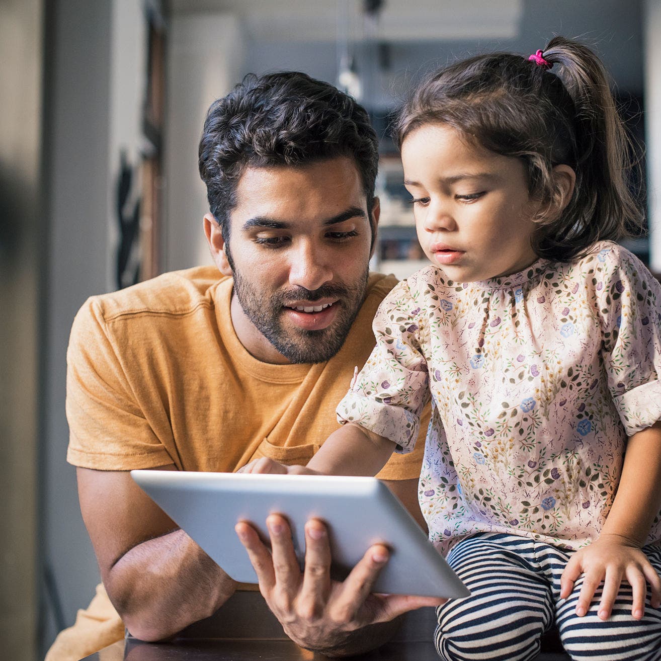 Father and daughter using a tablet