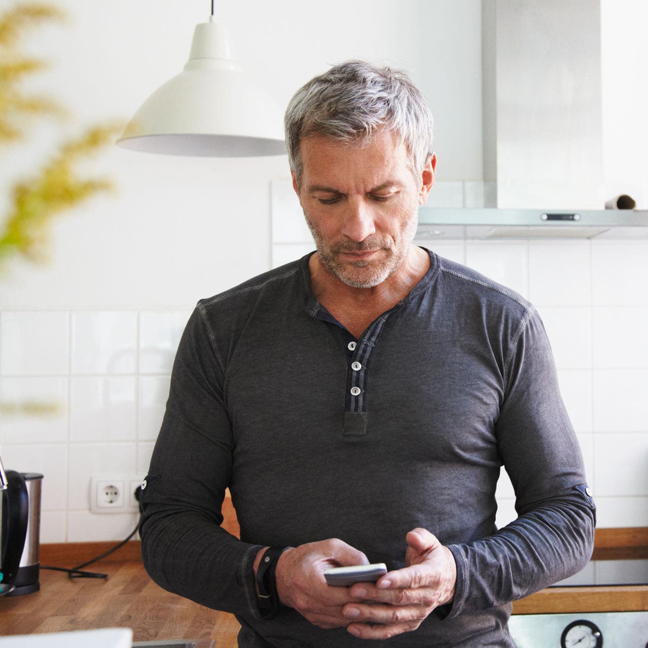 man using smartphone at home