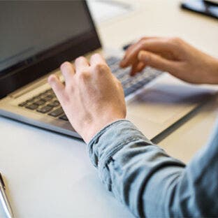 man using laptop in office