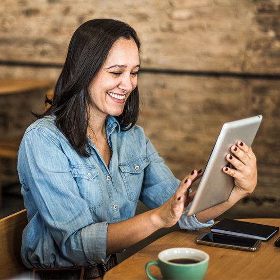 woman using tablet in coffee shop