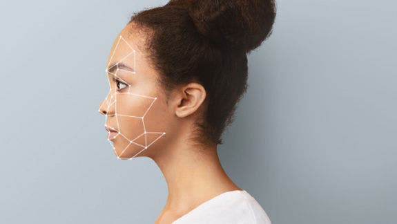 Woman in profile with facial recognition grid