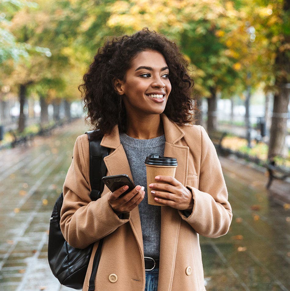 lady with coffee and her phone