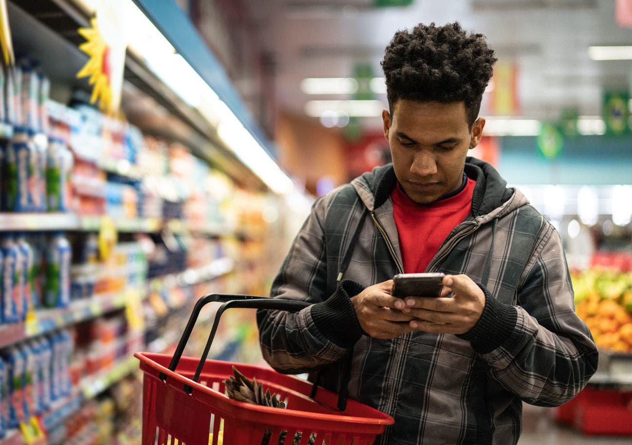 man using smartphone at the supermarket