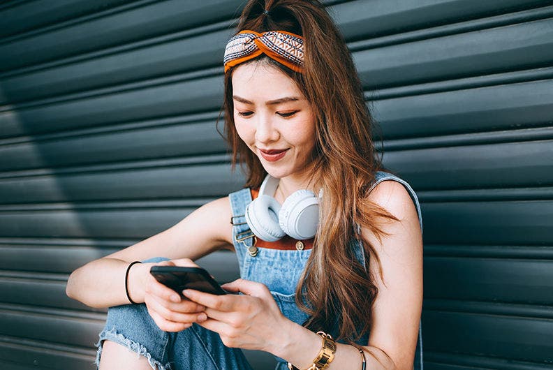 Woman reading mobile phone.