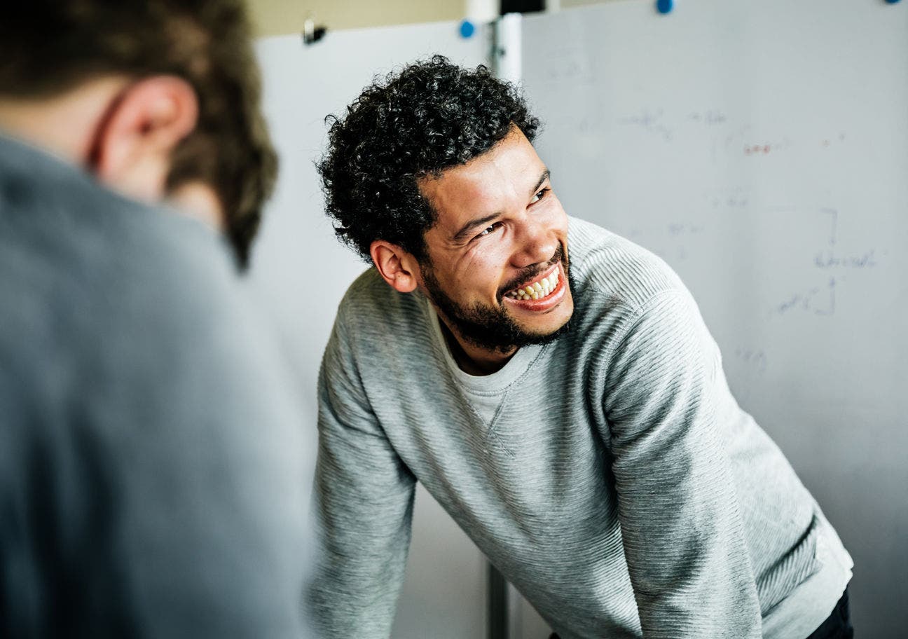 man smiling during a brainstorming session