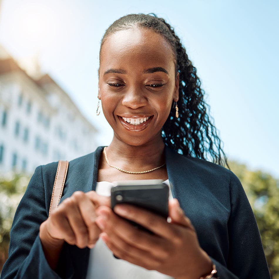 girl looking at her phone smiling