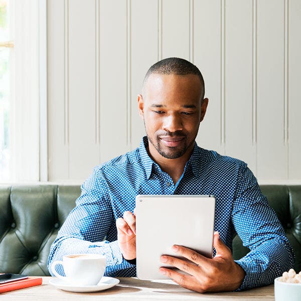 man sitting with tablet