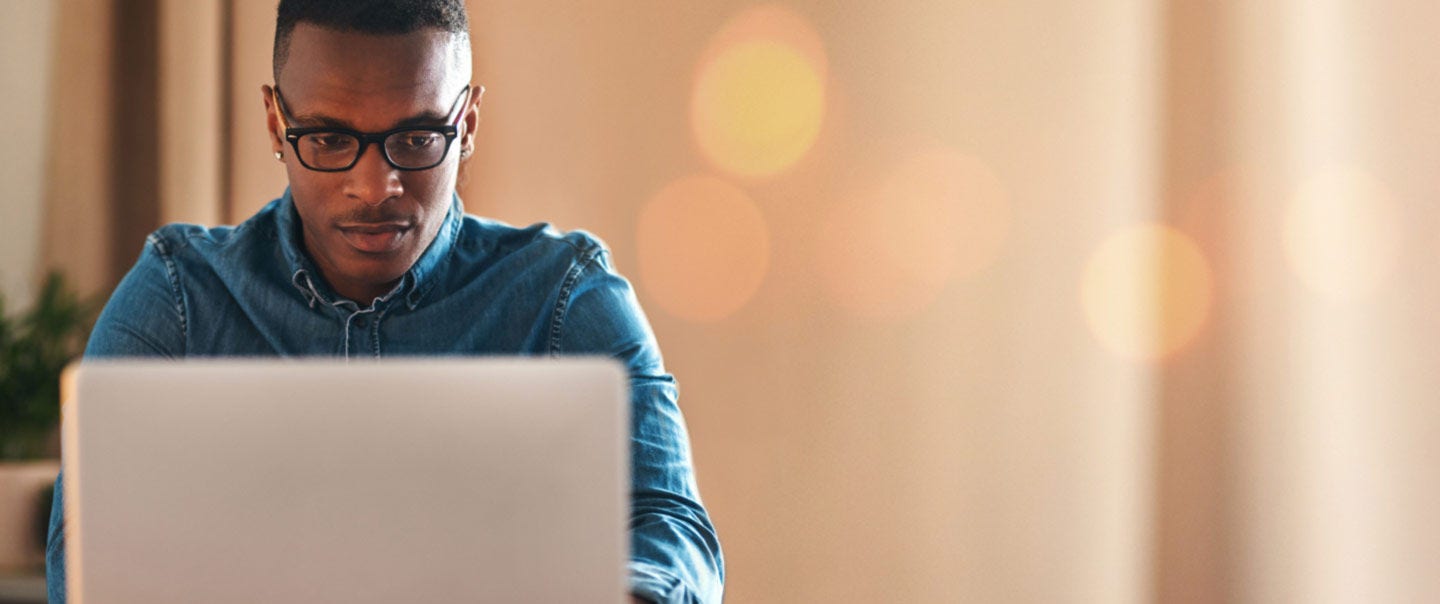 Person using a laptop to review a free annual credit report online