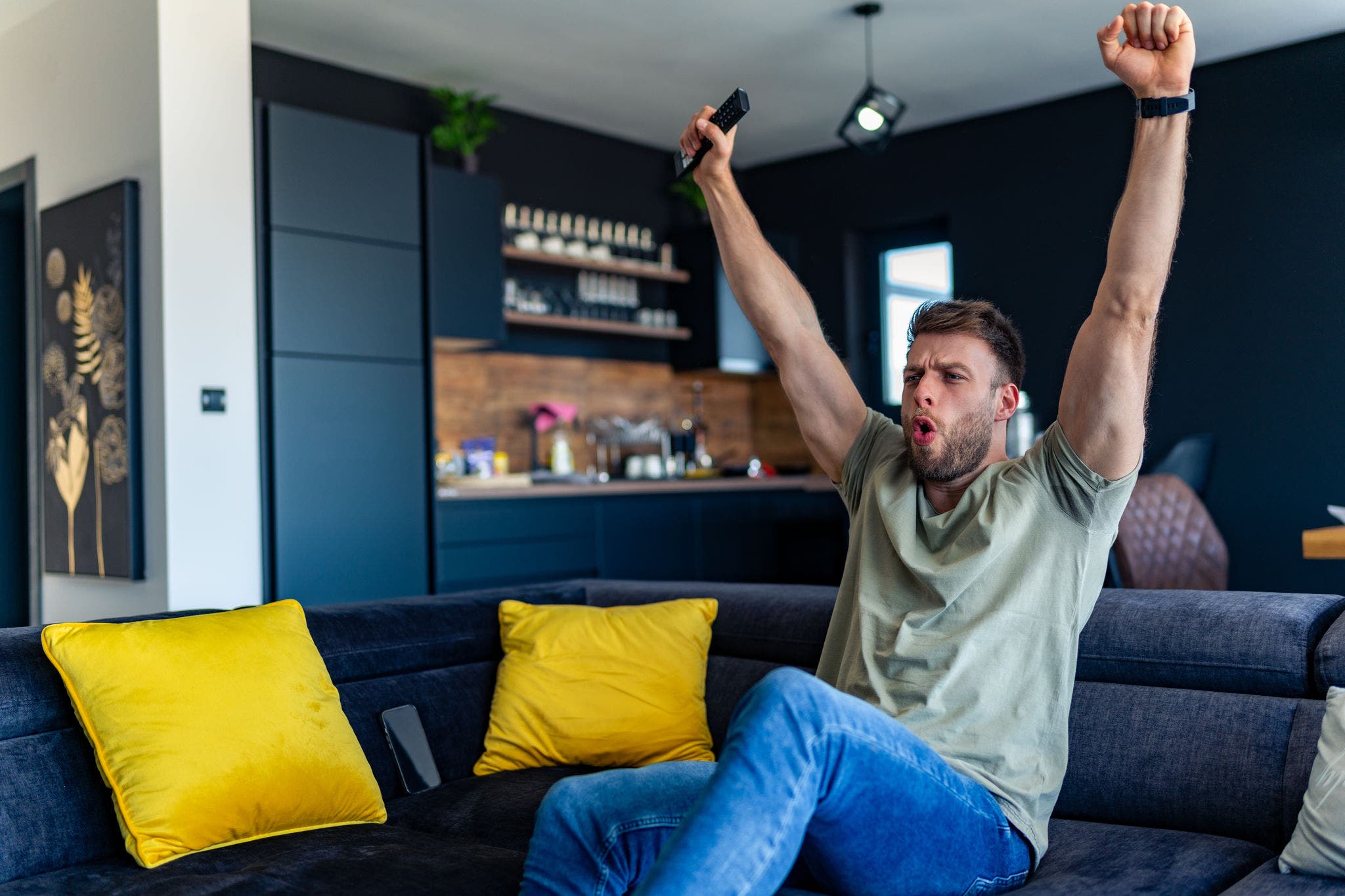 A man excitedly celebrates his team's goal in the championship