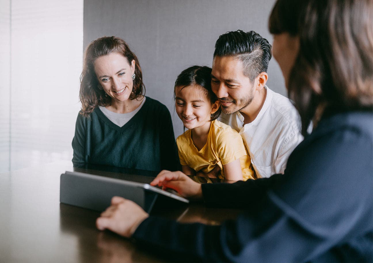 multiethnic family looking at ipad