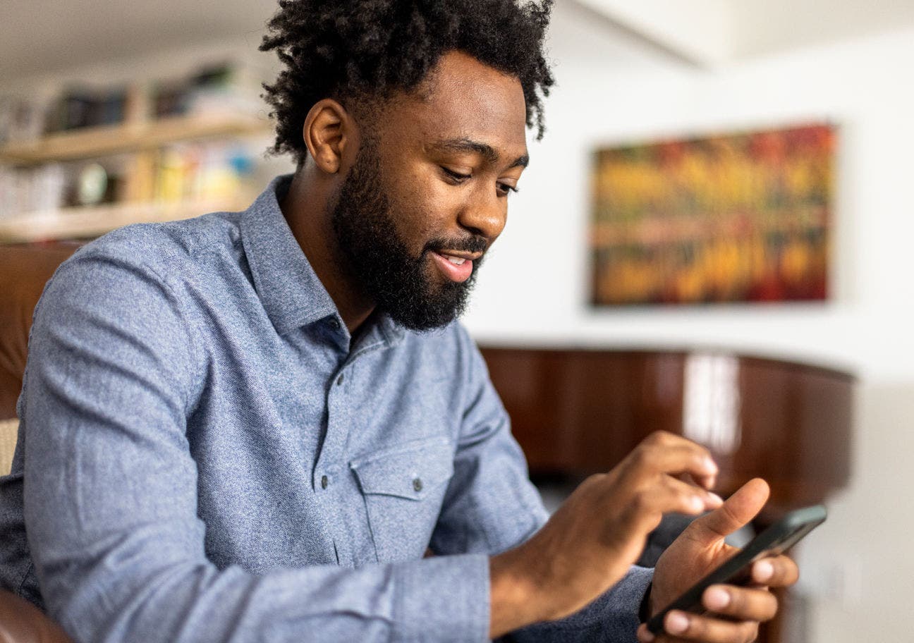 man using a smartphone at home