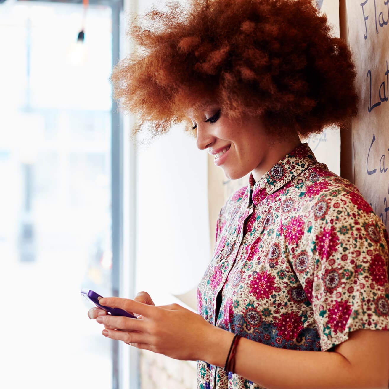 woman using smartphone in coffee shop