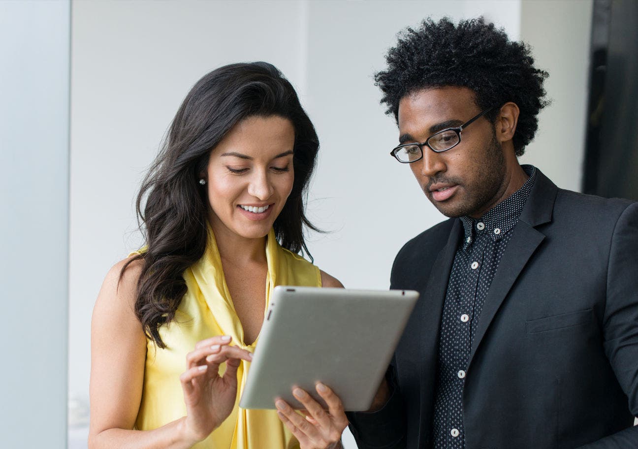 woman showing a man something on a tablet 