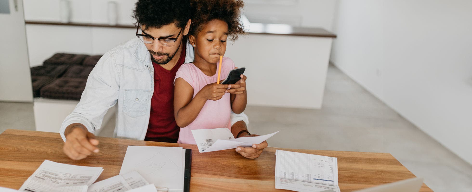 Father and daughter working on household budget.