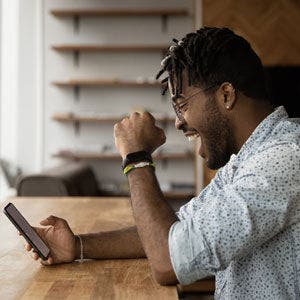 person celebrating with phone