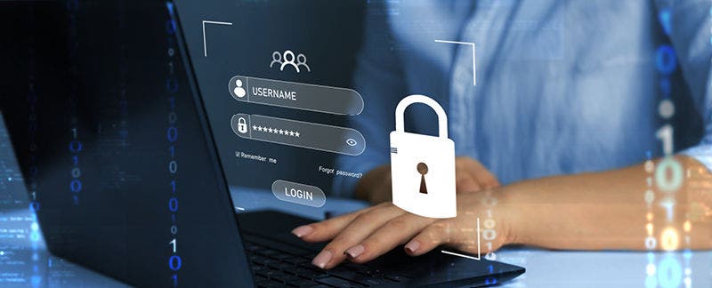 Image of a woman at a computer entering login credentials. 