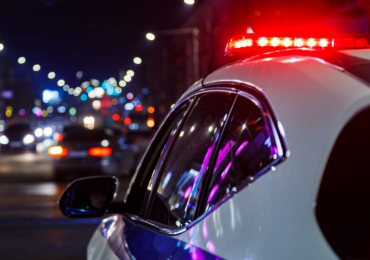 police car with lights on at night
