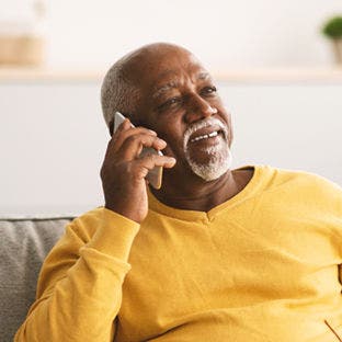 man on smartphone in house