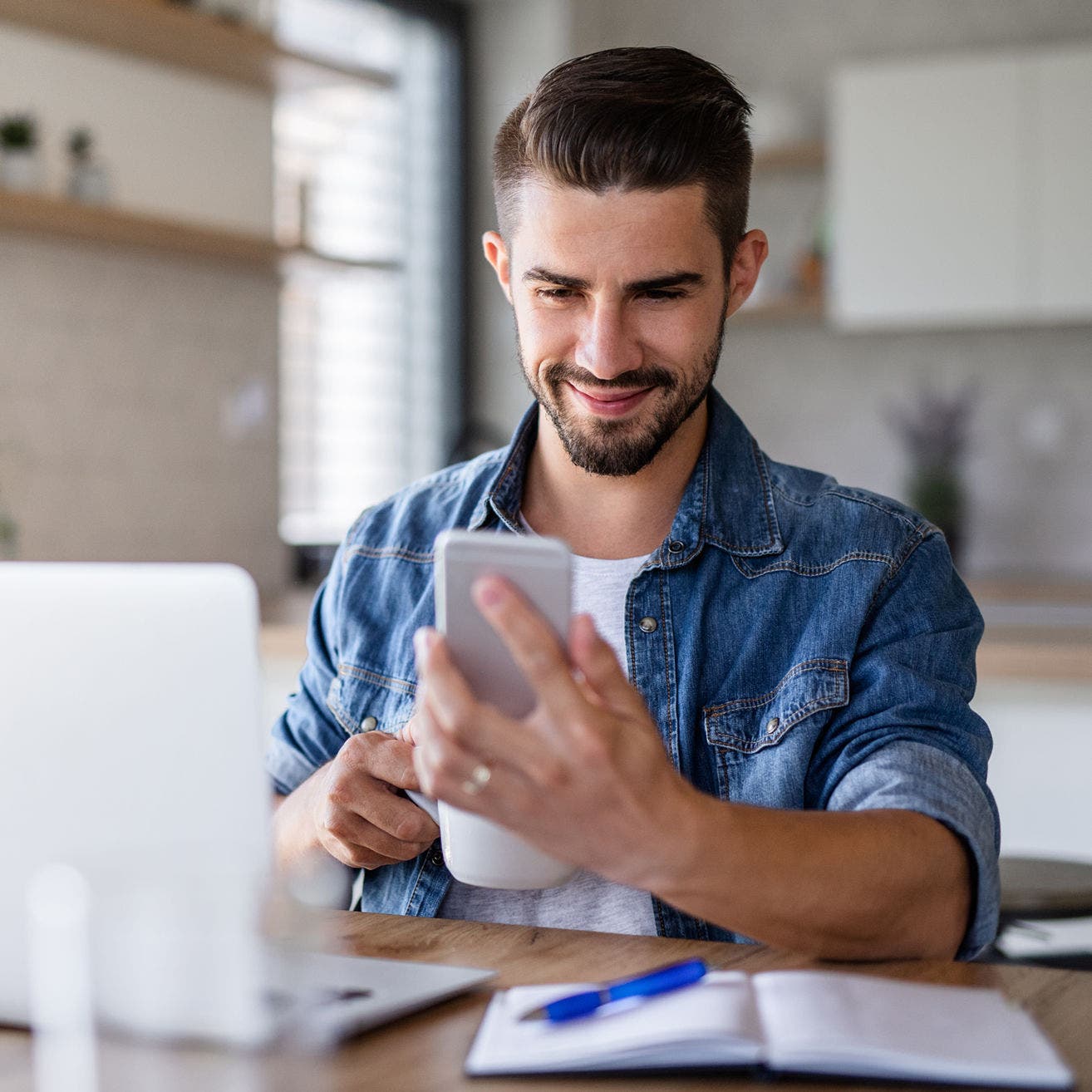 man using smartphone at desk
