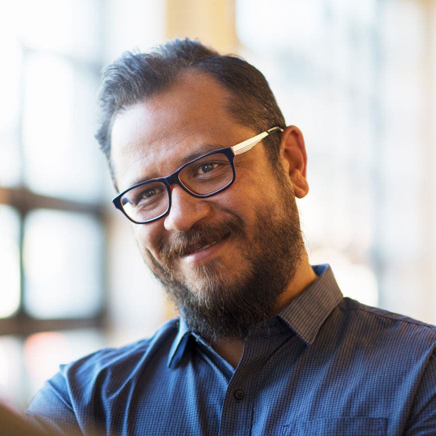 smiling bearded man with glasses