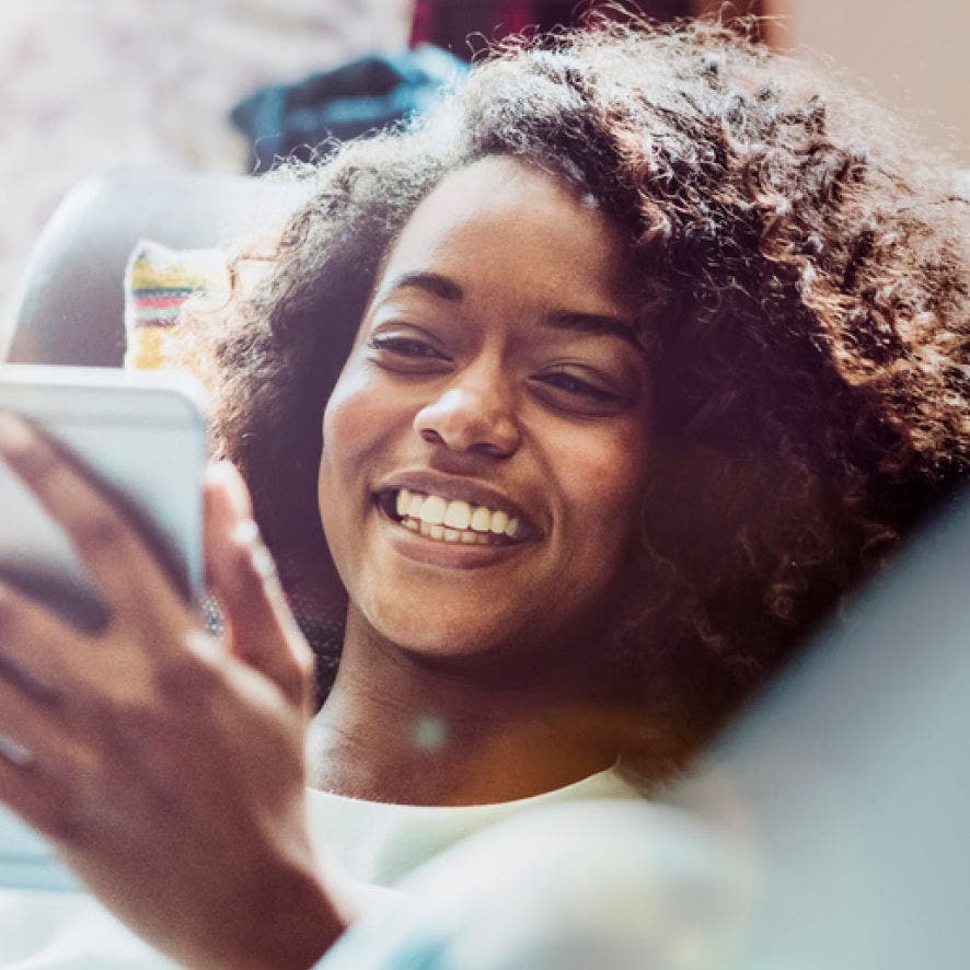 person smiling at phone