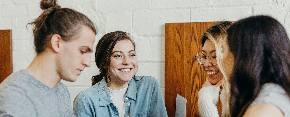 Image of people collaborating around a computer.