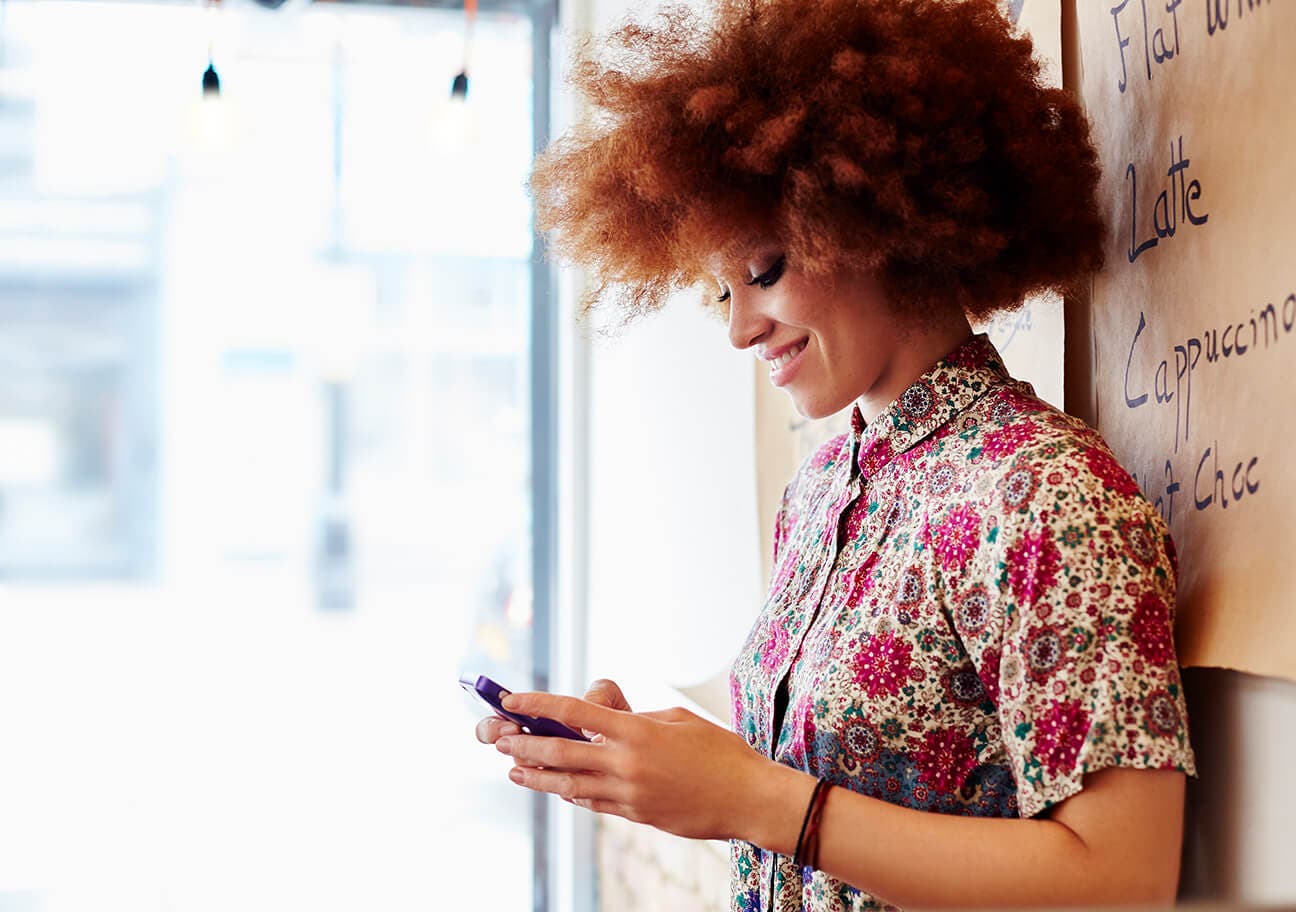 woman using mobile phone in cafe
