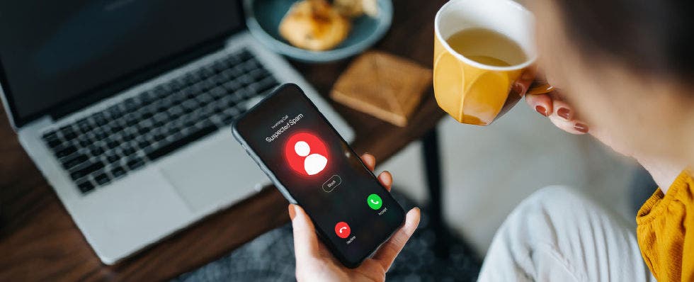 person on phone receiving spam call