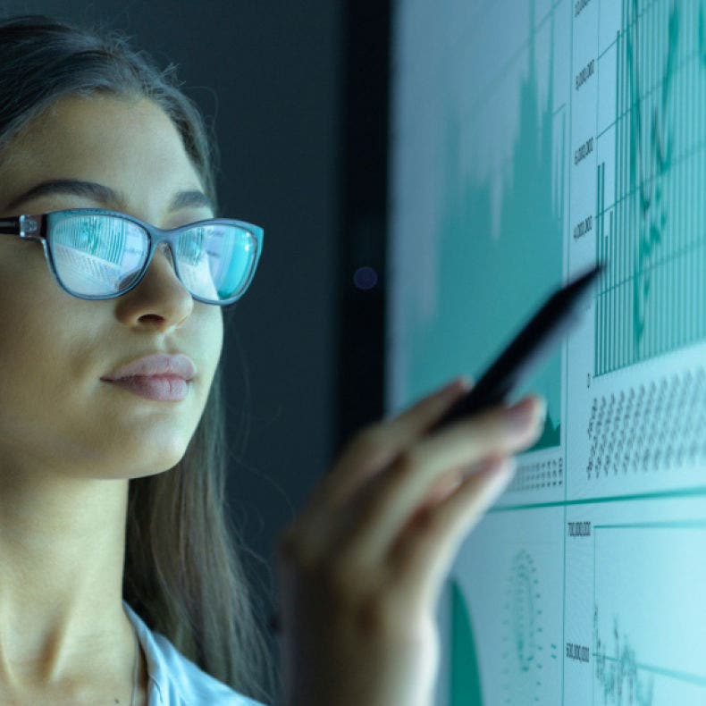 person with glasses looking at screen