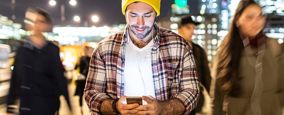 man looking at phone in public