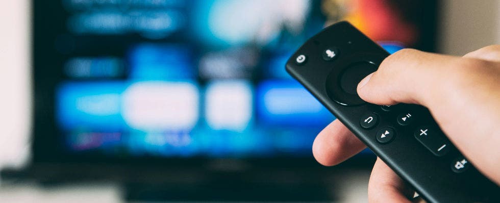 Image of a hand holding a remote control.
