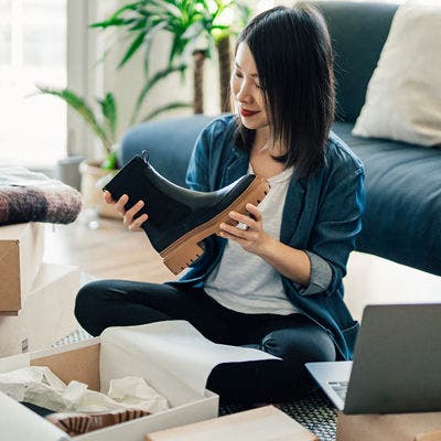 Woman unboxing a boot.