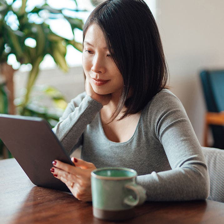 woman using tablet in coffee shop