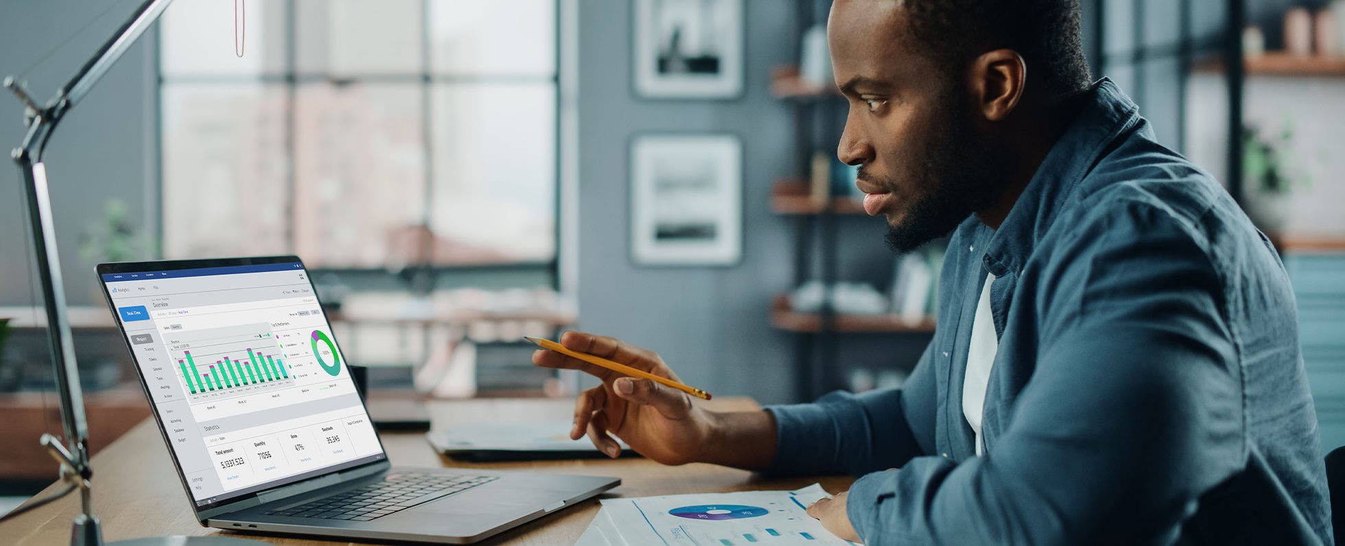Man sits at desk with laptop