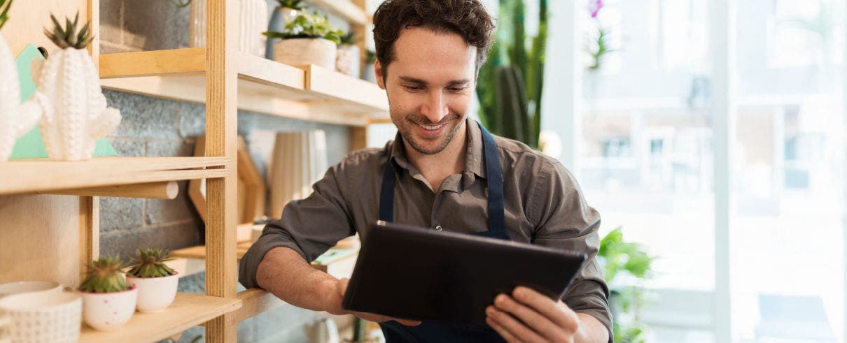 man at work looking at content on ipad