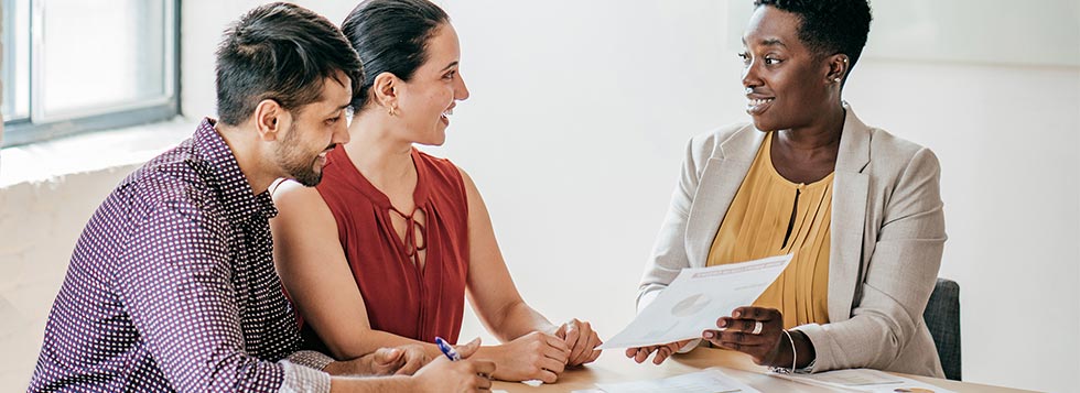 Woman showing loan paperwork man and woman
