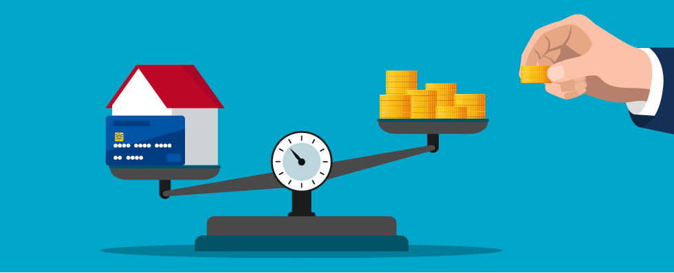 Scale with home and credit card tipped lower on the left  and coins on the left. 