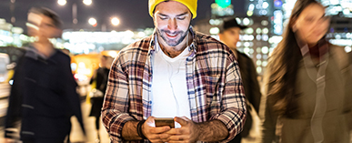 man looking at phone in public