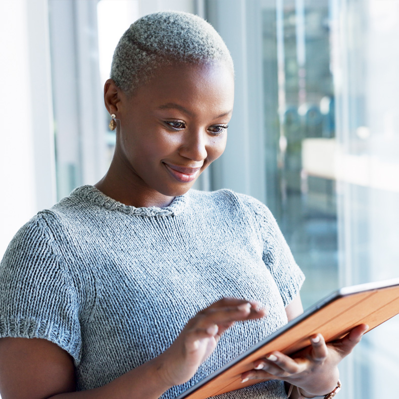 image of woman looking at tablet