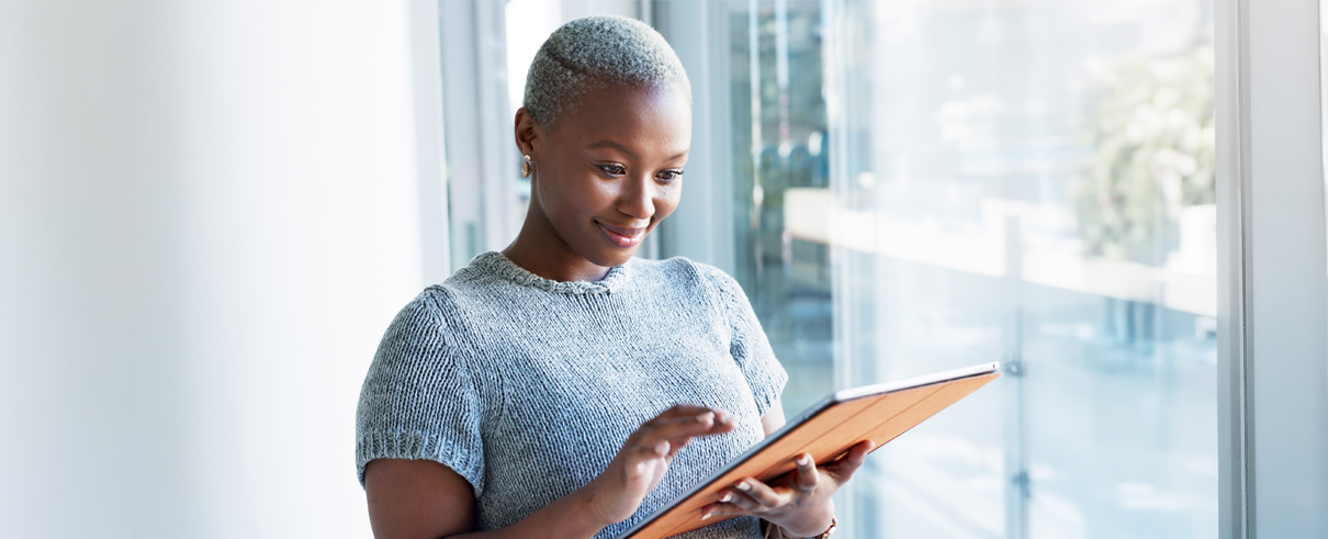 image of woman looking at tablet