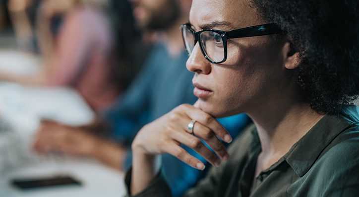 Woman with glasses looking at computer screen
