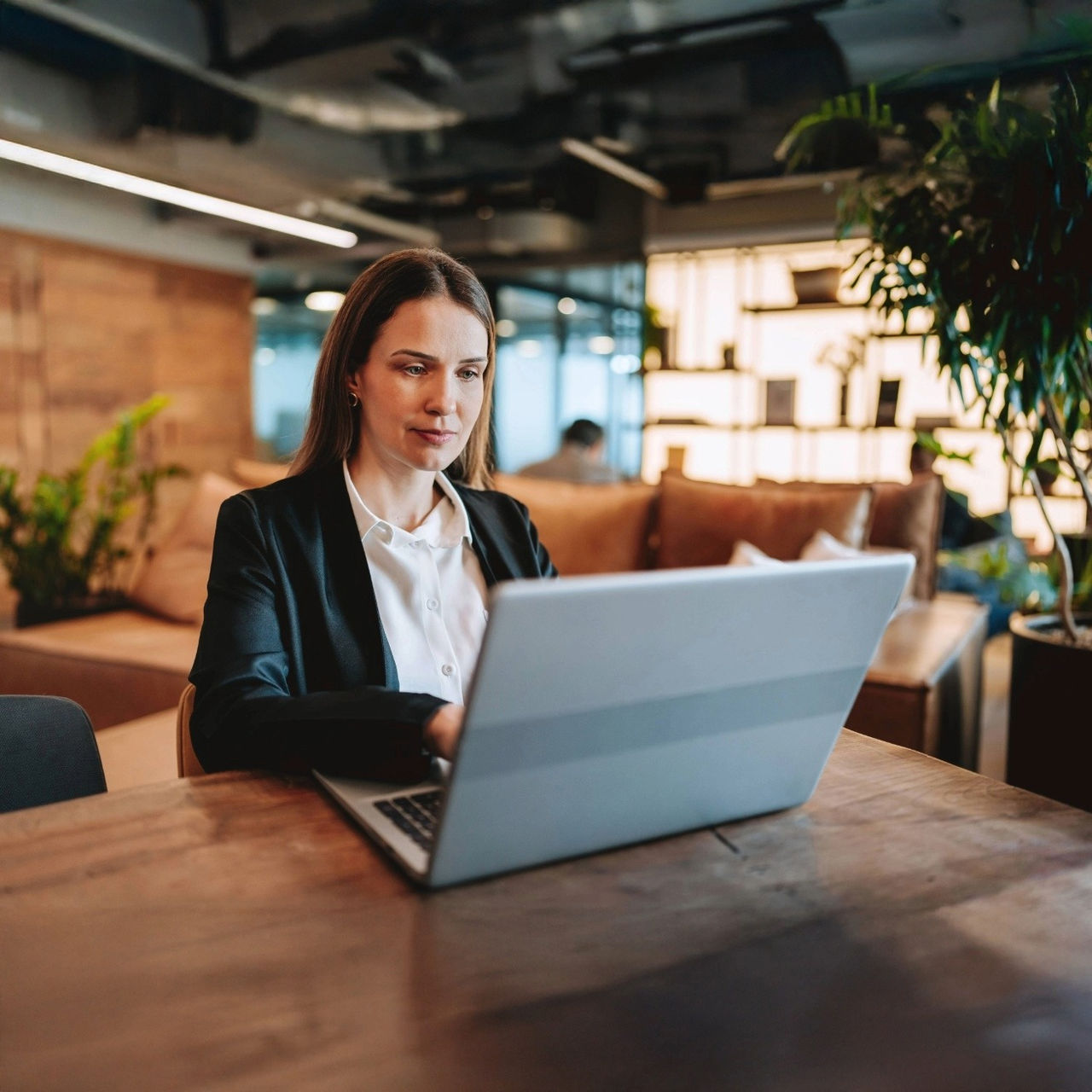 TruIQ CSS lady looking at laptop