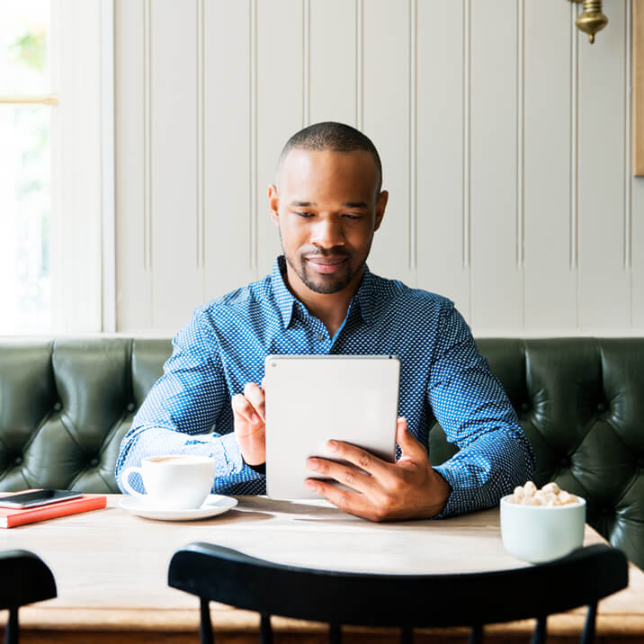 business man using tablet in cafe