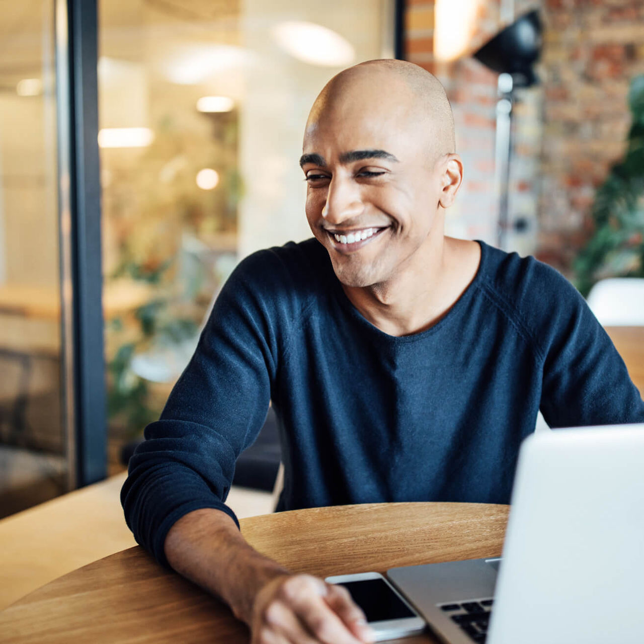 man working on laptop in cafe