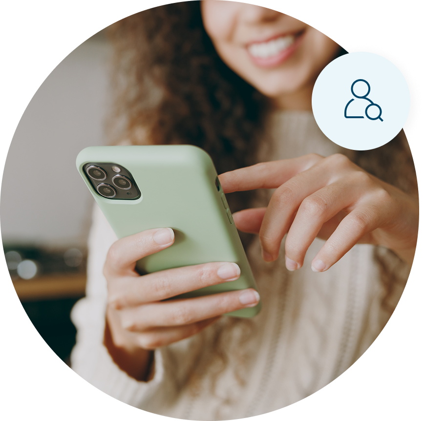 A woman holding a green mobile phone